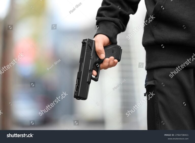 stock-photo-man-with-gun-outdoors-closeup-2764738411